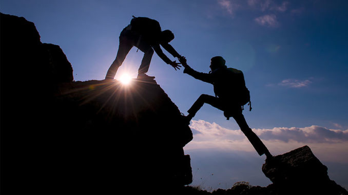 helping-another-on-the-rock-face