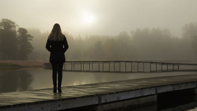 woman-on-a-pier-in-the-fog