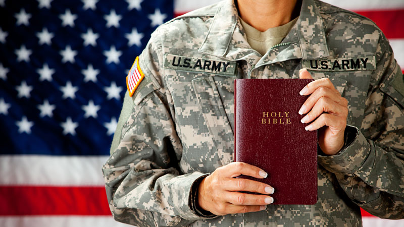 Soldier-holding-bible