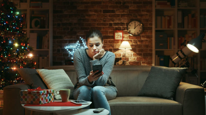 Woman-on-cell-phone-waiting-on-christmas